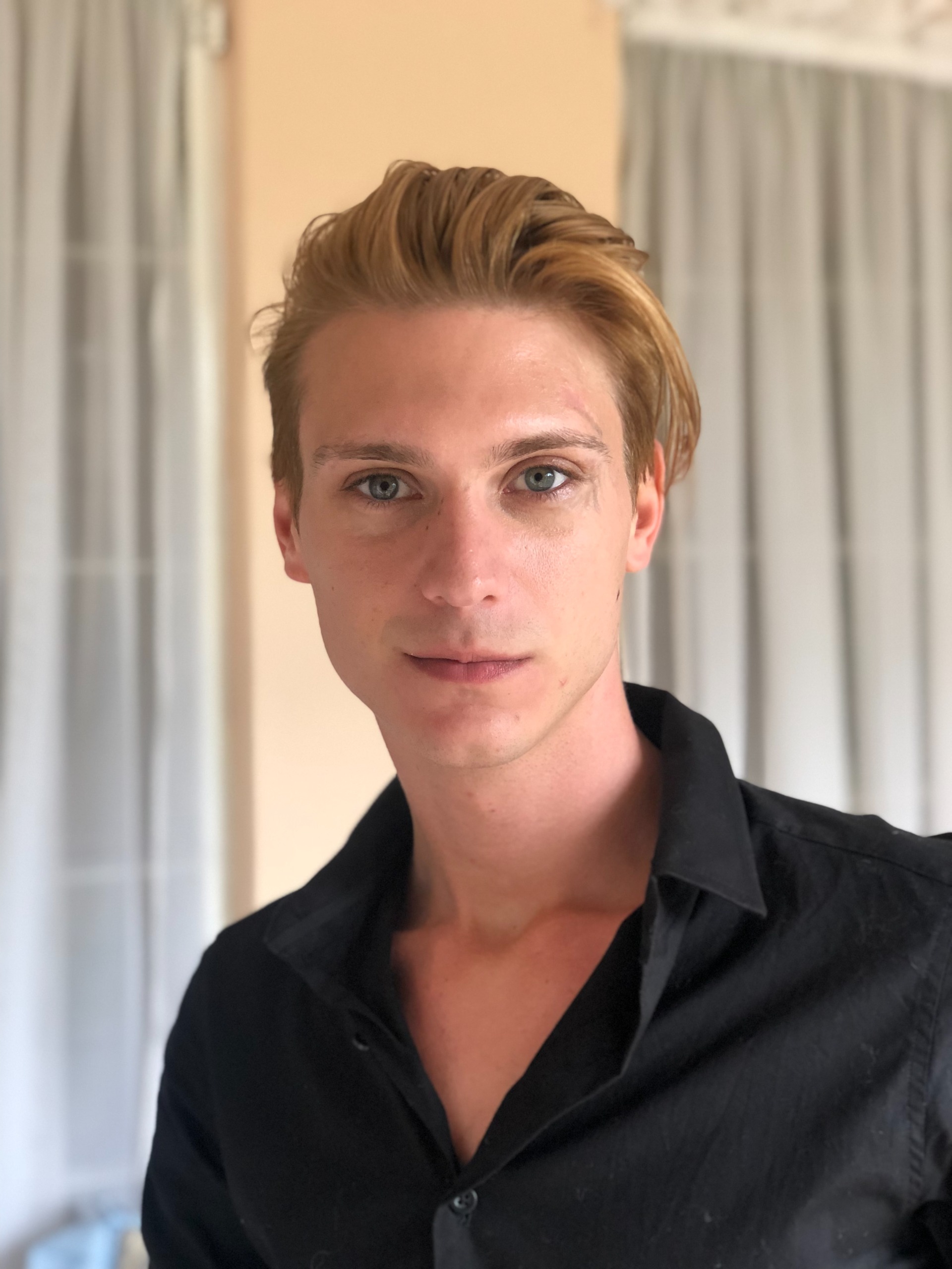 Professional headshot of Zander, strategic architect and business strategist at Arkatype Studios, against a clean architectural backdrop